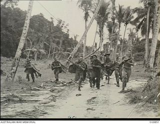 KIRIWINA, TROBIAND ISLANDS, PAPUA. C. 1944-03. GUARDS OF NO. 30 (BEAUFIGHTER) SQUADRON RAAF "CHARGING" THROUGH A COCONUT PLANTATION IN A GROUND DEFENCE TRAINING EXERCISE