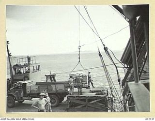 PORT MORESBY, NEW GUINEA. 1944-04-28. SUPPLIES BEING UNLOADED FROM THE STEAM SHIP MONTORO ON TO TRUCKS FOR TRANSPORTATION TO NO.5 BASE SUPPLY DEPOT. THE DOCKS ARE OPERATED BY MEMBERS OF THE 2/1ST ..