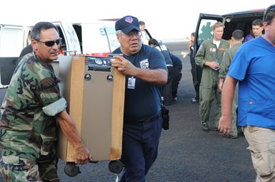 Earthquake ^ Tsunami - Pago Pago, American Samoa, October 5, 2009 -- Officials from the U. S. Department of Health and Human Services (HHS) begin the transfer of medical equipment on board a Coast Guard C-130 vital to support the well being of the infant during flight. DMATs are part of the U. S. Department of Health and Human Services' National Disaster Medical System which supports hospitals and other medical and public health needs of communities during disasters such as the earthquake and tsunami disaster in American Samoa. FEMA/Casey Deshong