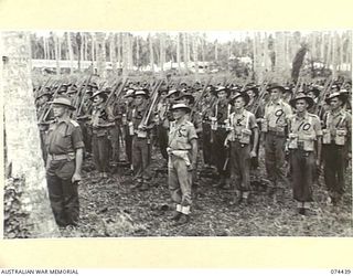 MADANG, NEW GUINEA. 1944-07-01. A JOIN-UP PHOTOGRAPH OF A MORNING PARADE OF THE 24TH INFANTRY BATTALION. TO JOIN TO PHOTOGRAPHS NO. 74438, 74440 AND 74441. IDENTIFIED PERSONNEL ARE:- VX104151 ..