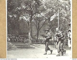 ELA BEACH, NEW GUINEA. 1943-11-13. AN AUSTRALIAN PIPE BAND PARADING ON THE SPORTS GROUND DURING AN INTERVAL IN THE PROGRAM AT THE COMBINED SERVICES SPORTS MEETING