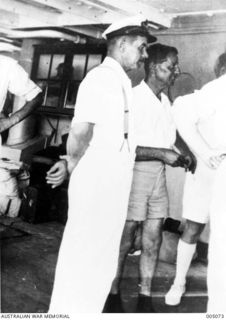 EMIRAU ISLAND. THE CAPTAIN OF THE NORWEGIAN MERCHANT VESSEL VINNI WITH CAPTAIN UPTON OF THE BRITISH VESSEL RANGITANE, BOTH OF WHOSE SHIPS WERE SUNK BY GERMAN RAIDERS KOMET AND ORION IN THE PACIFIC, ..