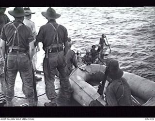 BLUP BLUP ISLAND, NEW GUINEA. 19 JUNE 1944. NEW GUINEA NATIVES APPROACHING A UNITED STATES NAVY TORPEDO BOAT CARRYING A PATROL FROM THE 24TH INFANTRY BATTALION WHO ARE INVESTIGATING RUMOURS OF A ..