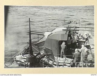 MADANG, NEW GUINEA. 1944-10-30. THE MAIN ARMAMENT BEING FIRED DURING A PRACTICE SHOOT ABOARD THE RAN SLOOP, SWAN