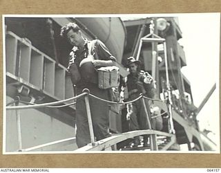 TOWNSVILLE, QLD. 1944-01-28. PERSONNEL OF THE 24TH INFANTRY BRIGADE PROCEEDING DOWN THE GANGWAY OF THE TROOPSHIP, "VAN HEUTSZ" ON THEIR RETURN TO AUSTRALIA FROM NEW GUINEA