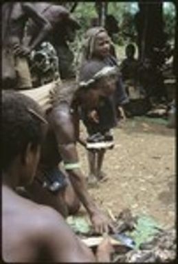 Woman kneeling to grab food