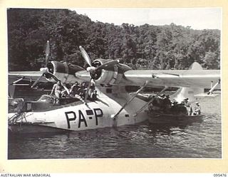 NANTAMBU, NEW BRITAIN, 1945-08-22. TROOPS OF 37/52ND INFANTRY BATTALION LOADING THEIR GEAR FROM A LAUNCH INTO A ROYAL NEW ZEALAND AIR FORCE CATALINA AIRCRAFT. THE BATTALION WAS AIRLIFTED BACK TO ..