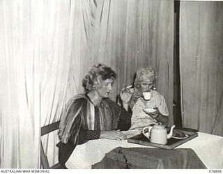 LAE AREA, NEW GUINEA. 1945-01-31. "THE TEA PARTY", STAGED DURING THE CAMPFIRE CONCERT OF THE 22ND WORKS COMPANY. IDENTIFIED PERSONNEL ARE:- VX104118 MAJOR R.C. UPSTON, OFFICER IN CHARGE (1); QX6520 ..