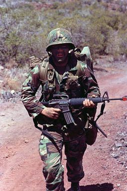 Sergeant Tim Blobaum, team leader, Company C, 1ST Battalion, 14th Infantry, 25th Infantry Division, moves toward high ground during a training exercise at the US Army's Pohakuloa Training Area. The 25th Infantry Division is preparing for Team Spirit '84