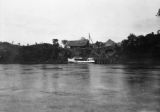 Papua New Guinea, boat at pier with houses on coastline