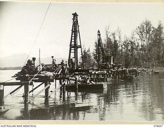 MOTUPENA POINT, BOUGAINVILLE ISLAND, 1945-01-26. SAPPERS OF THE 23RD FIELD COMPANY, WORKING ON THE CONSTRUCTION OF A NEW TIMBER PILE BRIDGE OVER THE JABA RIVER