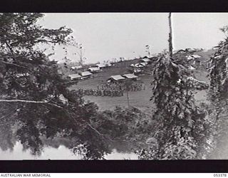 DONADABU, SOGERI VALLEY, NEW GUINEA. 1943-06-28. LOOKING ACROSS LALOKI RIVER, HEADQUARTERS COMPANY, 61ST AUSTRALIAN INFANTRY BATTALION, ON PARADE AT THE DONADABU TRAINING CAMP