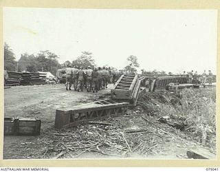 LAE, NEW GUINEA. 1944-08-09. TROOPS OF THE 20TH FIELD COMPANY, CARRYING SECTIONS OF A NEW STEEL BOX GIRDER BRIDGE TO THE EDGE OF THE BUTIBUM RIVER WHERE THEY ARE BUILDING A NEW BRIDGE TO REPLACE ..