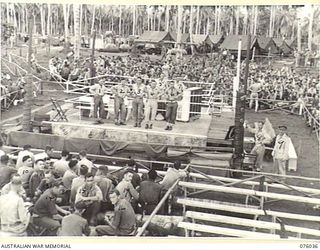 MADANG, NEW GUINEA. 1944-09-16. THE EARLY CROWD AT THE TEMPORARY STADIUM WAITING FOR THE COMMENCEMENT OF THE BOXING AND WRESTLING COMPETITIONS TO START BETWEEN TEAMS FROM THE RAN, AMF AND THE RAAF. ..