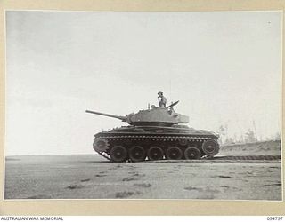 TOROKINA AREA, BOUGAINVILLE, 1945-08-06. AN M24 GENERAL CHAFFEE LIGHT TANK SILHOUETTED DURING TRIALS ON BEACH SAND CONDUCTED FOR THE WAR OFFICE