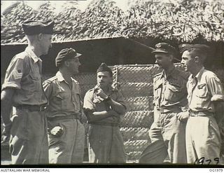 VIVIGANI, GOODENOUGH ISLAND, PAPUA. C. 1944-10. OFFICERS AND NCOS DISCUSS THE ATTACK ON RABAUL BY A COMBINED BEAUFORT BOMBER FORCE FROM NOS. 6, 8 AND 100 SQUADRONS RAAF