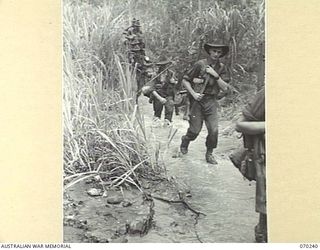 FARIA VALLEY, NEW GUINEA. 1944-02-09. PERSONNEL OF "B" COMPANY, 2/10TH INFANTRY BATTALION, CROSS THE FARIA RIVER ON THE JOURNEY TO THE RAMU VALLEY AFTER BEING RELIEVED BY THE 58/59TH INFANTRY ..