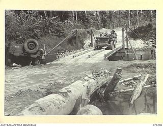 BOUGAINVILLE ISLAND. 1945-02-17. A JEEP OF THE 9TH INFANTRY BATTALION CROSSING A BRIDGE OVER THE HOPAI RIVER ON THE MOSIGETTA ROAD BUILT BY THE TROOPS OF THE 5TH FIELD COMPANY