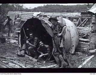 WAREO, NEW GUINEA. 1943-12-09. VX35138 PRIVATE (PTE) A. HIRST OF LANCEFIELD, VIC (1) AND SX7022 PTE R. C. POYNTER OF SEMAPHORE, SA (2) RECEIVING A VISIT FROM TX4599 PTE C. MORGAN OF HOBART, TAS (3) ..