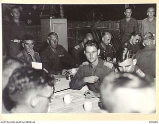 TOKO, BOUGAINVILLE. 1945-08-28. MAJOR GENERAL W. BRIDGEFORD, GENERAL OFFICER COMMANDING 3 DIVISION AT THE OFFICIAL TABLE DURING THE DINNER HELD BY STAFF OFFICERS OF HEADQUARTERS 3 DIVISION, TO ..