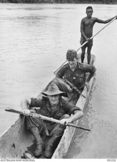 RAMU RIVER, FAITA AREA, NEW GUINEA. 1944-01-07. CORPORAL K. J. MONK OF GIPPSLAND, VIC (1) AND VX47342 LIEUTENANT K. S. CURRAN OF GLENFERRIE, VIC (2) OF THE 2/2ND COMMANDO SQUADRON BEING FERRIED ..