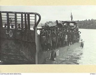 MALAMAL, NEW GUINEA. 1944-07-13. NATIVES ABOARD AN LCM (LANDING CRAFT MECHANISED) WHICH IS TAKING THEM BACK TO THE AUSTRALIAN NEW GUINEA ADMINISTRATIVE UNIT NATIVE LABOUR COMPOUND AFTER THEIR DAYS ..