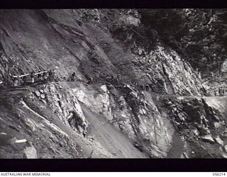 REINHOLD HIGHWAY, NEW GUINEA. 1943-08-22. THE ROCK FACE OF STEELE FALLS DURING THE FINAL STAGES OF THE HIGHWAY CONSTRUCTION BY ENGINEERS OF THE 9TH AUSTRALIAN FIELD COMPANY, ROYAL AUSTRALIAN ..