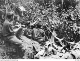 Mount Tambu fighting. Members of 2/5 Battalion firing mortars at Japanese positions 60 yards away. Left to right: NX115759 Private (Pte) Athol James Butler of Bathurst, NSW; VX27151 Pte Findlay ..