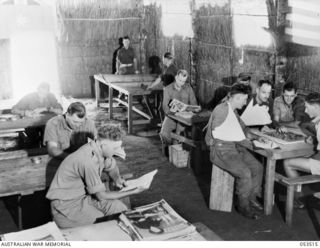 SOGERI VALLEY, NEW GUINEA, 1943-06-25. PATIENTS OF THE 11TH AUSTRALIAN FIELD AMBULANCE, MAIN DRESSING STATION, IN THEIR RECREATION HUT. N437969 PRIVATE (PTE) N. P. ELLIS; Q48648 PTE R. W. BARTLEM; ..