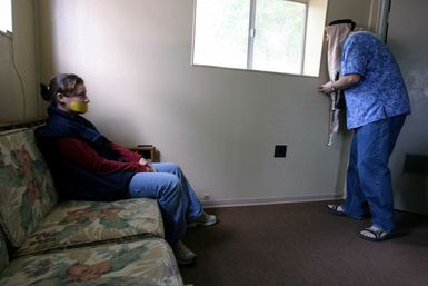 A hostage, played by U.S. Marine Corps CPL. Lozor, Marine Forces Pacific Band, watches a terrorist, played by U.S. Navy Randal H. Hughes, an Assistant Special Agent in Charge of the Naval Criminal Investigative Service Hawaii Field Office, during training at the Marine Corps Base Hawaii on Dec. 9, 2004.(U.S. Marine Corps official photo by CPL. Nicholas Riddle) (Released)