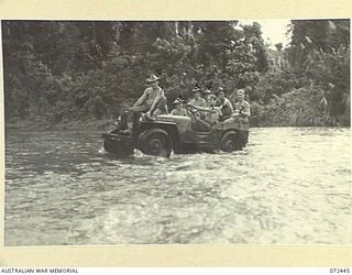 AMBOGA RIVER, NEW GUINEA. 1944-04-17. A JEEP CARRYING MEMBERS OF THE 24TH LINE SECTION, 18TH LINES OF COMMUNICATION SIGNALS FORDING THE RIVER. THE JEEPS CAN SUPPLY SIGNAL STATIONS AS FAR AS AWALA. ..