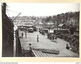 THE WHARF, JACQUINOT BAY, NEW BRITAIN, 1945-08-13. HEADQUARTERS 5 DIVISION AND ATTACHED TROOPS COMING ALONG THE WHARF TO EMBARK FOR RETURN TO AUSTRALIA ON THE TROOPSHIP VAN OUTHOORN