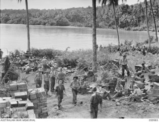 LANGEMAK BAY, NEW GUINEA, 1943-10-28. THE BEACHHEAD AT THE WESTERN END OF THE BAY BEFORE THE EMBARKATION OF THE 2/24TH AUSTRALIAN INFANTRY BATTALION. SHOWN ARE:- NX23114 SERGEANT E.G. STEINBECK ..