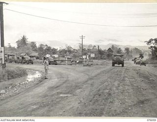 LAE, NEW GUINEA. 1944-09-21. NX52007 LIEUTENANT J.P. DELANEY, NEW GUINEA FORCE PROVOST COMPANY INSPECTING THE TRAFFIC POST AT CHARING CROSS