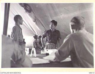 CAPE WOM, NEW GUINEA. 1945-10-19. CORPORAL YAMAMOTO, OF THE JAPANESE ARMY, BEING QUESTIONED AT HEADQUARTERS 6 DIVISION, BY THE WEWAK WAR CRIMES COMMISSION, WHICH IS COLLECTING SUMMARIES OF EVIDENCE ..