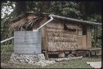 Hutchins' house with cistern to catch rainwater from corrugated metal roof