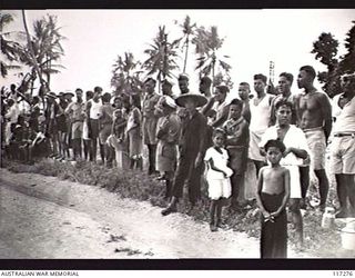 NAURU ISLAND. 1945-09-14. A SECTION OF THE NATIVE AUDIENCE WHO ARE ATTENDING THE FLAG RAISING CEREMONY SOON AFTER TROOPS OF THE 31/51ST INFANTRY BATTALION TOOK OVER THE AREA