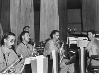 LAE, NEW GUINEA. 1944-10-03. A UNIT DANCE BAND IN FULL SWING DURING AN OTHER RANKS DANCE TENDERED TO MEMBERS OF THE AUSTRALIAN ARMY MEDICAL WOMEN'S SERVICE IN THE NEW RECREATION HALL OF THE 22ND ..