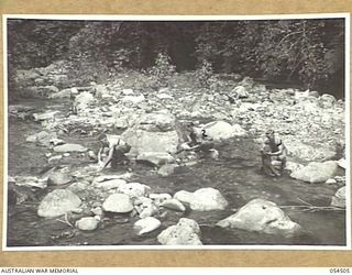 MUBO-SALAMAUA AREA, NEW GUINEA, 1943-07-22. TROOPS OF THE 2/5TH AUSTRALIAN INFANTRY BATTALION DOING THEIR WASHING IN BUIGAP CREEK. LEFT TO RIGHT:- SX5731 PRIVATE J.A. SLACK; NX109801 PRIVATE F.G. ..