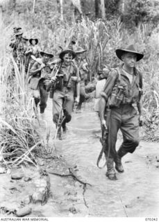 FARIA VALLEY, NEW GUINEA. 1944-02-09. PERSONNEL OF "B" COMPANY, 2/10TH INFANTRY BATTALION, CROSS THE FARIA RIVER ON THE JOURNEY TO THE RAMU VALLEY AFTER BEING RELIEVED BY THE 58/59TH INFANTRY ..