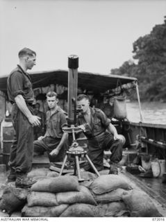 MEMBERS OF THE 101ST BRIGADE SUPPORT COMPANY, HEADQUARTERS 5TH DIVISION ALONGSIDE A 4.2 INCH MORTAR MOUNTED ON SANDBAGS ABOARD A LANDING CRAFT MECHANIZED DURING PRACTICE EXERCISES FOR EXPERIMENTAL ..