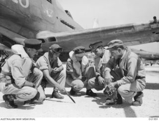 TADJI NEAR AITAPE, NORTH EAST NEW GUINEA. C. 1944-10. TARGET FOR TOMORROW IS DISCUSSED BY RAAF CREWS OF NO. 8 (BEAUFORT) SQUADRON RAAF AND US AIR FORCE PERSONNEL ON THE AIRSTRIP. AUSTRALIAN AND ..