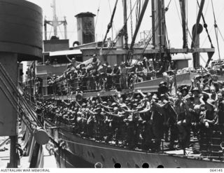 TOWNSVILLE, QUEENSLAND, AUSTRALIA. 1944-01-28. PERSONNEL OF THE 24TH INFANTRY BRIGADE ABOARD THE TROOPSHIP "VAN HEUTSZ" IMPATIENTLY WAITING TO LAND IN AUSTRALIA AFTER A LONG TOUR OF DUTY IN NEW ..