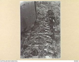 MADANG, NEW GUINEA. 1944-10. TANK TRACKS LIFTING THROUGH THE ACCUMULATION OF MUD DURING TESTS CONDUCTED AT HQ 4 ARMOURED BRIGADE