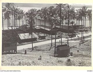 JACQUINOT BAY, NEW BRITAIN. 1945-06-09. THE RED CROSS SOCIETY, YMCA AND AUSTRALIAN COMFORTS FUND STORE HUTS SITUATED JUST BELOW THE 5 BASE SUB-AREA