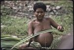 Weaving: pregnant woman strips spines from edges of pandanus leaves