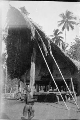 Pregnant woman standing beside a house pole under a gable, Sepik River, New Guinea, 1935 / Sarah Chinnery