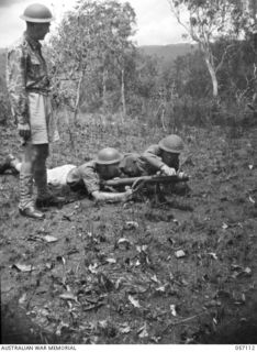SOGERI VALLEY, NEW GUINEA. 1943-09-19. PREPARING TO FIRE THE PROJECTOR INFANTRY TANK ATTACK MARK 1 DURING A TEST OF THE MISSILE AGAINST JAPANESE PILLBOXES. LEFT TO RIGHT: VX85020 LIEUTENANT S. P. ..