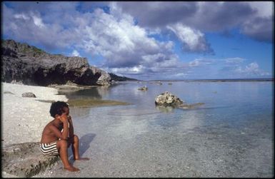 Young boy looking out to sea