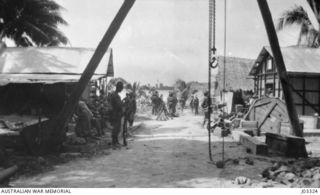 KABAKAUL, NEW GUINEA. 1914-09. AUSTRALIAN NAVY AND MILITARY EXPEDITIONARY FORCE (AN&MEF) TROOPS REEMBARKING AFTER A FIGHT AGAINST THE GERMANS. THE DESTROYER IN THE BACKGROUND IS THE "YARRA". (DONOR ..